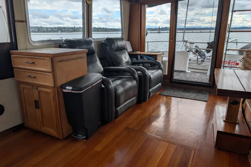 Slide: The Image of Interior of 1979 SUNYONG PS Trawler with leather chairs and wooden flooring, overlooking water. - 15