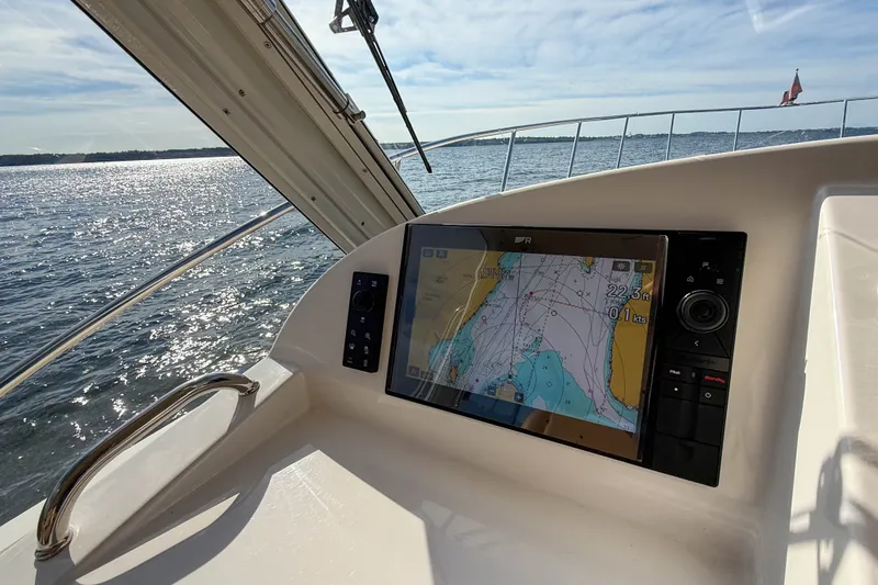 Slide: The Image of Helm of 2017 MJM 50z yacht with navigation display, overlooking sunny ocean waters. - 18