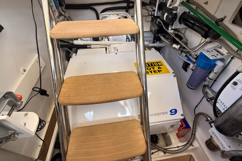 Slide: The Image of Engine room of 2017 MJM 50z yacht with equipment and wooden steps. - 58