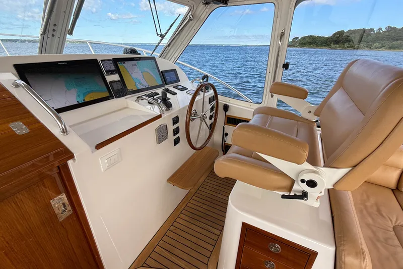 Slide: The Image of Luxurious 2017 MJM 50z yacht helm with leather seating and advanced navigation displays. - 22
