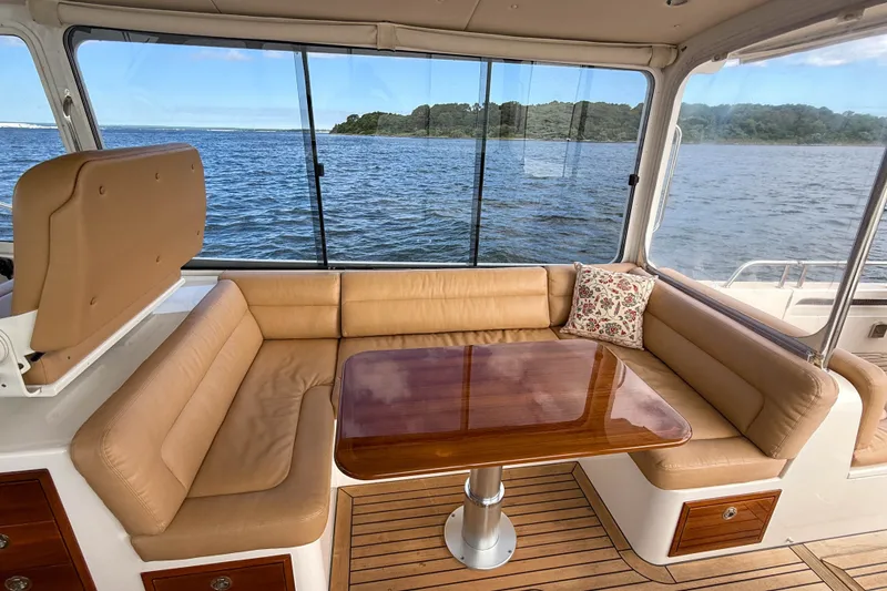 Slide: The Image of Luxurious interior of 2017 MJM 50z yacht with leather seating and wooden table. - 20