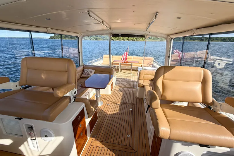 Slide: The Image of Luxurious interior of 2017 MJM 50z yacht with tan leather seating and scenic water view. - 47