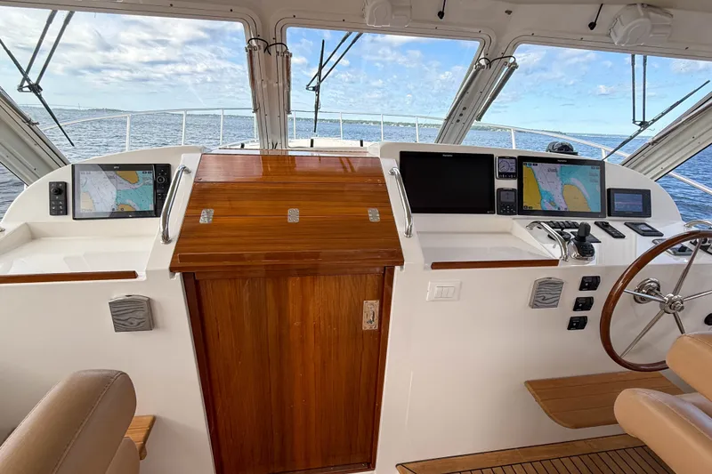 Slide: The Image of Helm of 2017 MJM 50z yacht with navigation screens and wooden accents. - 26