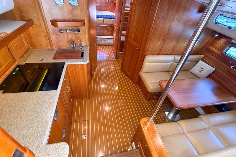 Slide: The Image of Luxurious 2017 MJM 50z yacht interior with wood finish, kitchenette, and seating area. - 28
