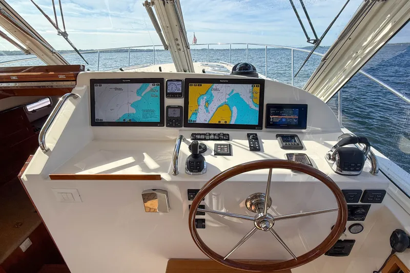 Slide: The Image of Helm of 2017 MJM 50z yacht with navigation screens and steering wheel, overlooking the ocean. - 23