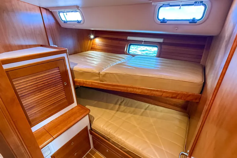 Slide: The Image of 2017 MJM 50z yacht cabin with wooden interior and bunk beds. - 36
