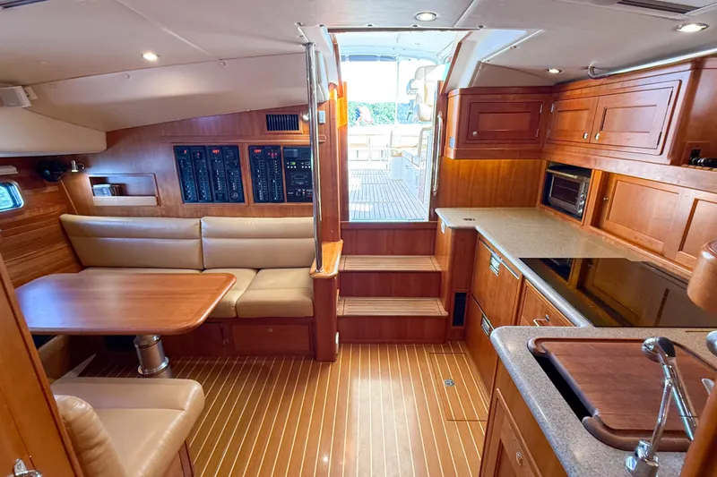 Slide: The Image of Luxurious 2017 MJM 50z yacht interior with wood finish, dining area, and modern kitchen. - 46