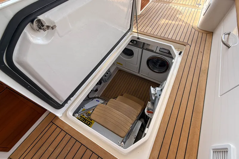 Slide: The Image of Hatch on 2017 MJM 50z yacht revealing laundry appliances below deck. - 56