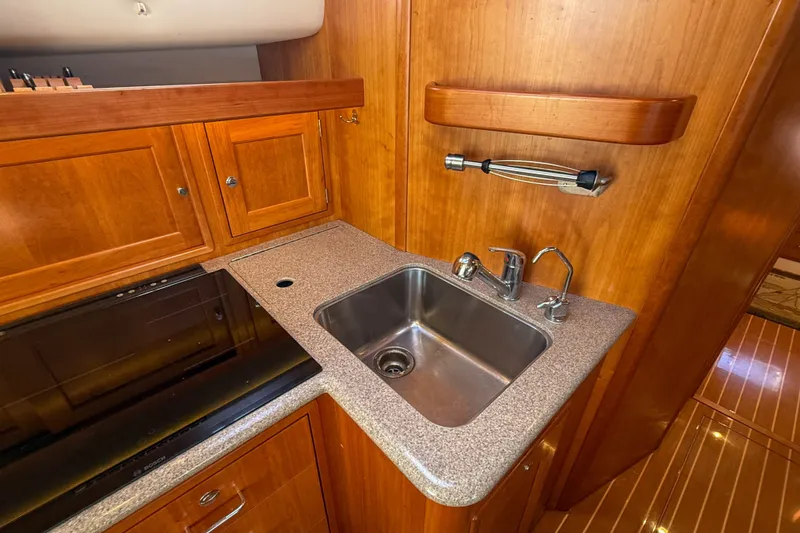 Slide: The Image of Luxurious 2017 MJM 50z yacht kitchen with wooden cabinetry and modern sink. - 33