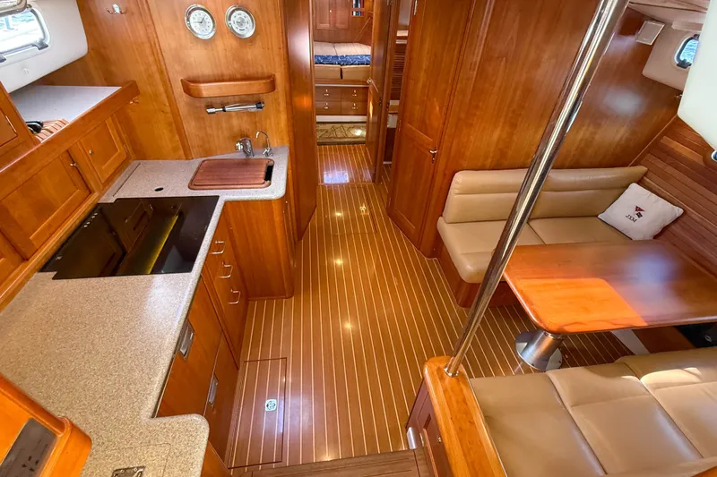 Slide: The Image of Luxurious 2017 MJM 50z yacht interior with wood finishes, kitchen, and seating area. - 27