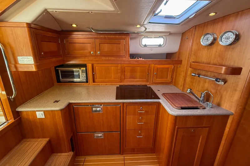 Slide: The Image of Luxurious 2017 MJM 50z yacht kitchen with wood cabinetry and modern appliances. - 30