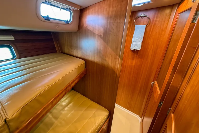 Slide: The Image of 2017 MJM 50z yacht interior with wooden paneling and bunk beds. - 37