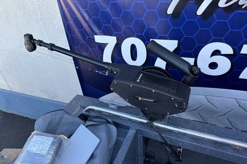 Slide: The Image of Cannon Magnum downrigger on 2025 Duckworth 20 Advantage boat, against a blue patterned background. - 27