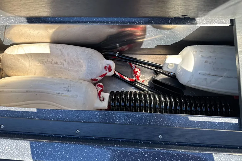 Slide: The Image of Storage compartment in a 2025 Duckworth 20 Advantage boat with fenders and accessories. - 28