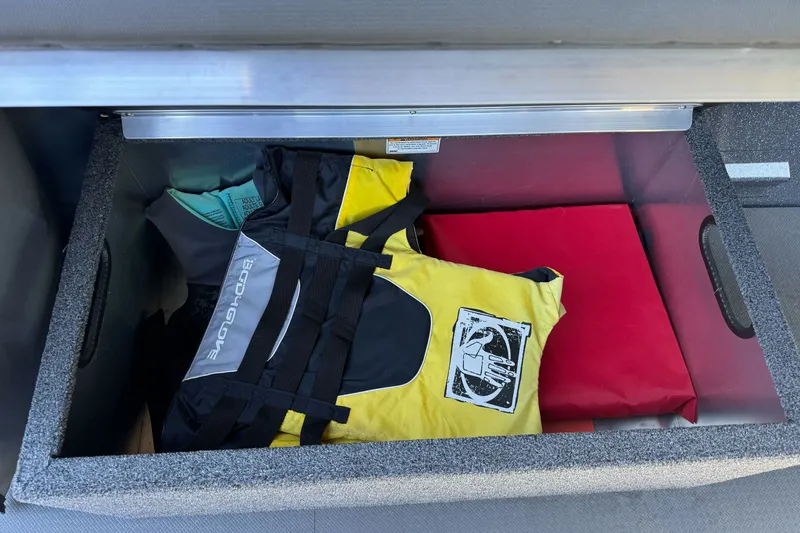 Slide: The Image of Storage compartment in a 2025 Duckworth 20 Advantage boat with life jackets and gear. - 16