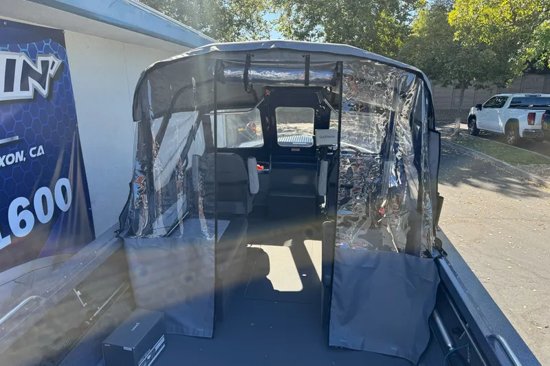 Slide: The Image of 2025 Duckworth 20 Advantage boat interior with protective covering, parked outdoors. - 14