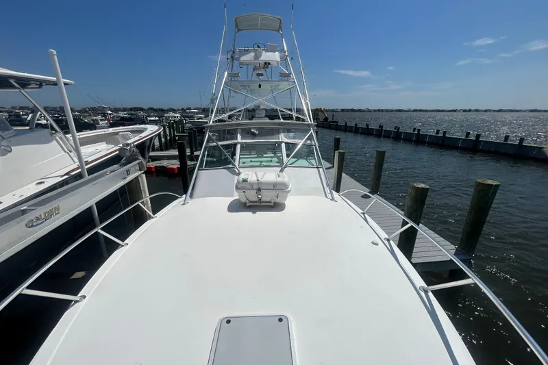 Slide: The Image of 2006 Topaz 40 Express boat docked at marina under clear blue sky. - 26