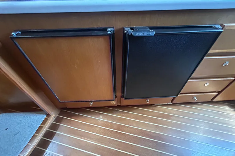 Slide: The Image of 2006 Topaz 40 Express interior with wooden cabinetry and black paneling. - 38