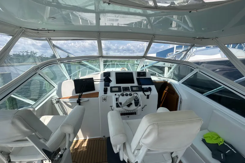 Slide: The Image of Helm of 2006 Topaz 40 Express boat with modern navigation equipment and white seating. - 14