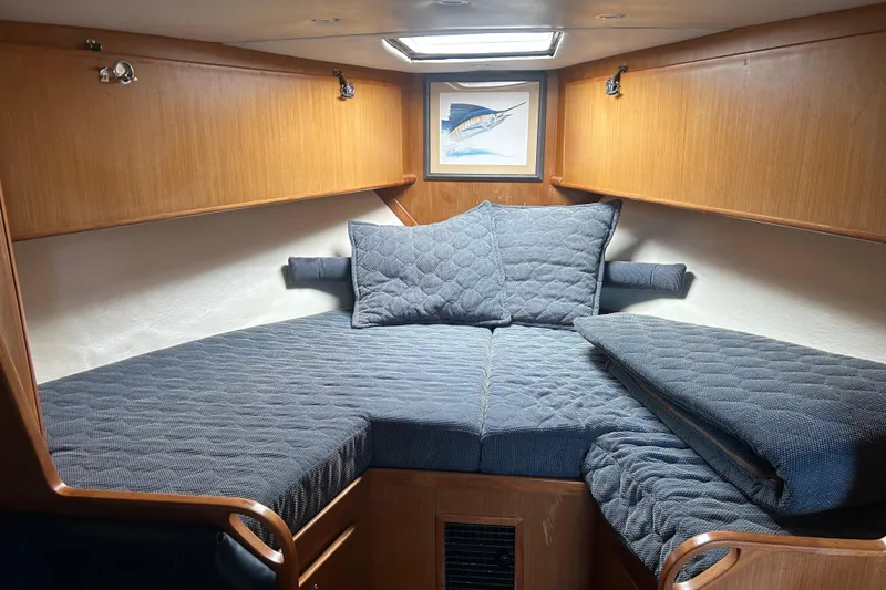 Slide: The Image of Cozy cabin interior of 2006 Topaz 40 Express yacht with quilted bedding and wooden accents. - 27