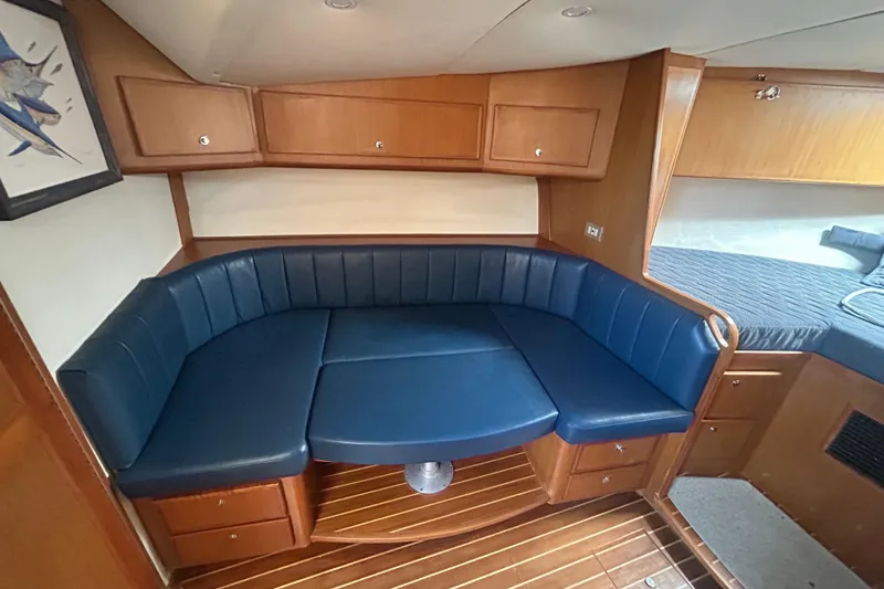 Slide: The Image of Interior of 2006 Topaz 40 Express yacht with blue seating and wooden cabinetry. - 33