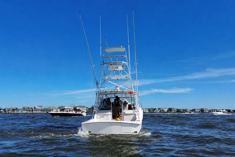 Slide: The Image of 2006 Topaz 40 Express boat cruising on a sunny day with clear blue skies. - 7