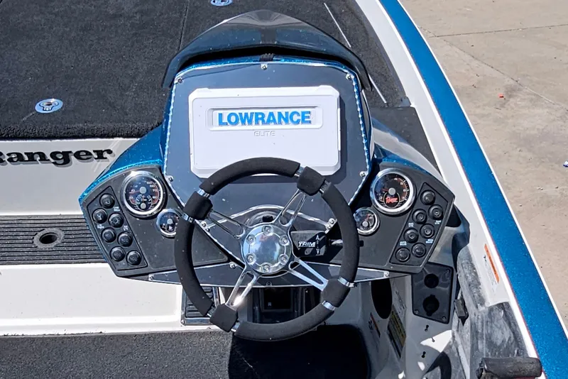Slide: The Image of 2014 Ranger Z518 Comanche boat dashboard with Lowrance Elite display and steering wheel. - 12