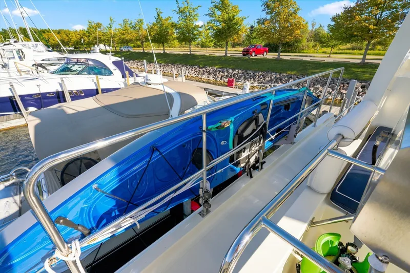 Slide: The Image of 2015 North Pacific NP49 yacht with blue kayak on deck, docked near trees. - 46