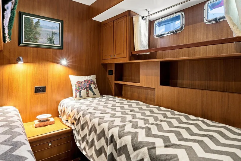 Slide: The Image of Cozy cabin interior of 2015 North Pacific NP49 yacht with twin beds and wooden decor. - 28