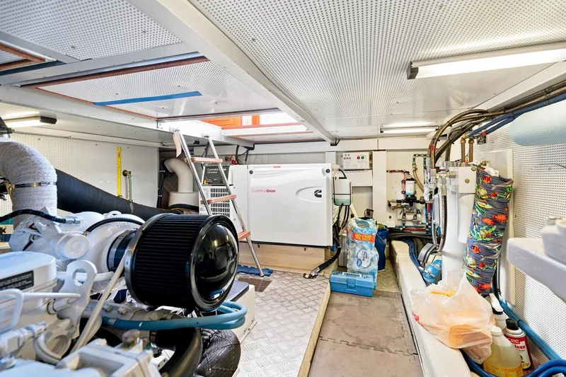 Slide: The Image of Engine room of a 2015 North Pacific NP49 yacht, featuring Cummins Onan generator. - 56