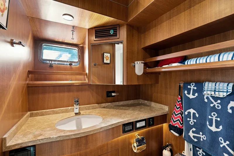 Slide: The Image of Luxurious 2015 North Pacific NP49 yacht bathroom with wood finish and nautical decor. - 31