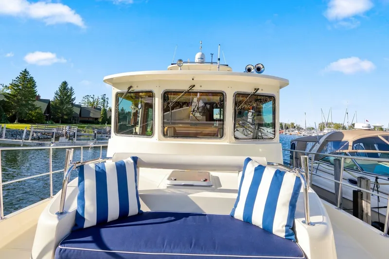 Slide: The Image of 2015 North Pacific NP49 yacht with striped cushions docked at a marina. - 49
