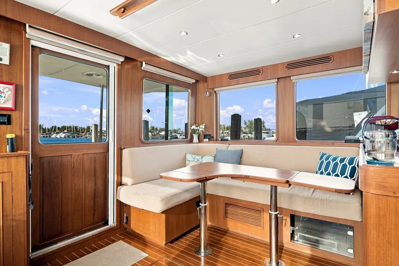 Slide: The Image of Interior of 2015 North Pacific NP49 yacht with cozy seating and wooden finishes. - 7