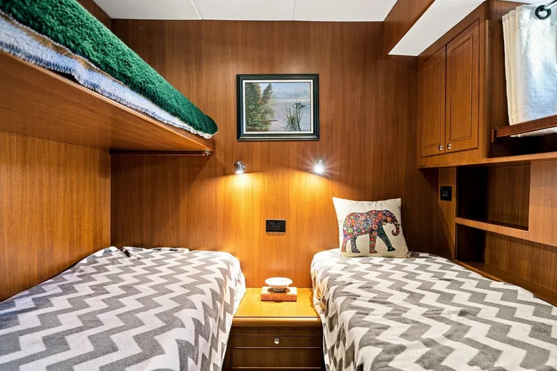 Slide: The Image of Cozy cabin interior of 2015 North Pacific NP49 with twin beds and wooden paneling. - 27