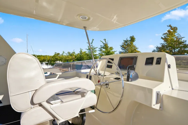 Slide: The Image of Helm of 2015 North Pacific NP49 yacht with steering wheel and navigation controls. - 39