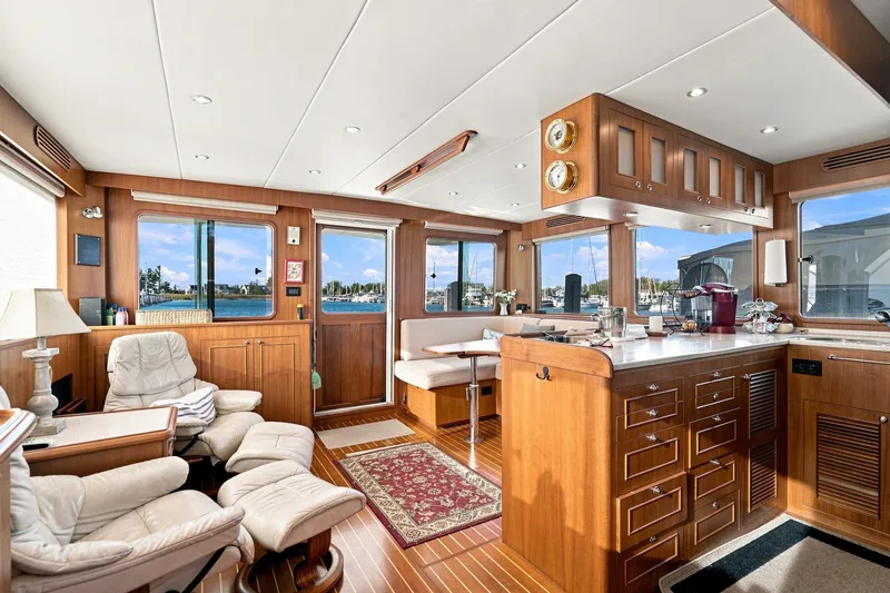 Slide: The Image of Luxurious 2015 North Pacific NP49 yacht interior with wood finish and waterfront views. - 4