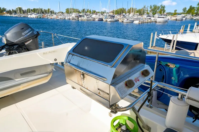 Slide: The Image of Outdoor grill on 2015 North Pacific NP49 yacht deck, marina view in background. - 42