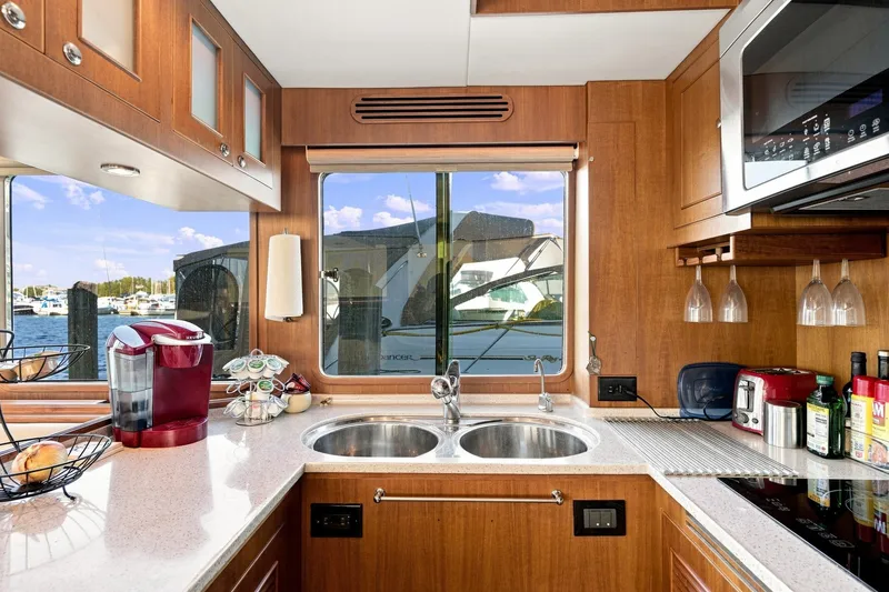 Slide: The Image of Luxurious kitchen interior of 2015 North Pacific NP49 yacht with modern appliances and scenic window view. - 10