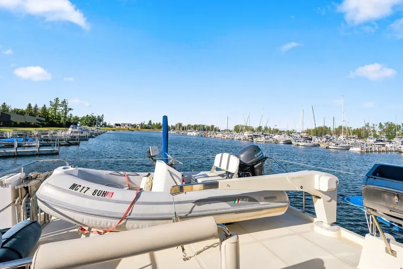 Slide: The Image of 2015 North Pacific NP49 yacht docked at marina with inflatable boat and clear blue sky. - 43