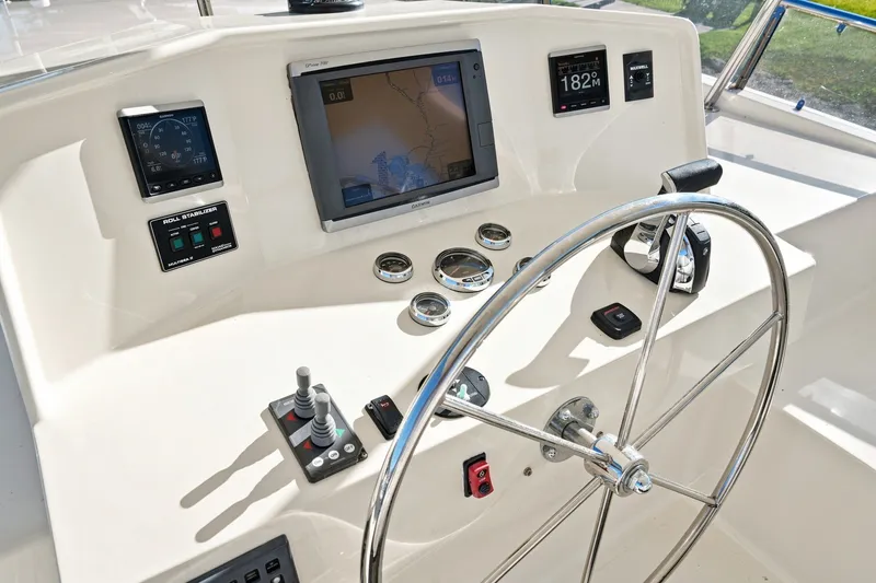 Slide: The Image of Helm of 2015 North Pacific NP49 yacht with navigation instruments and steering wheel. - 41