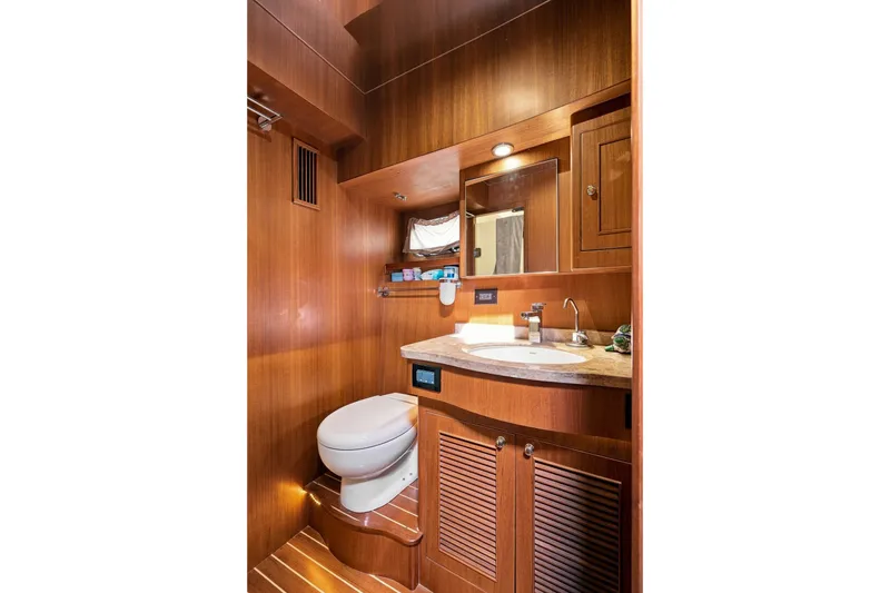 Slide: The Image of Luxurious wooden bathroom interior in 2015 North Pacific NP49 yacht, featuring sink and toilet. - 25