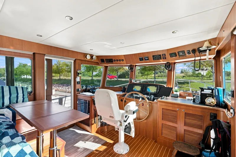 Slide: The Image of Interior of 2015 North Pacific NP49 yacht with wooden helm and modern navigation equipment. - 13