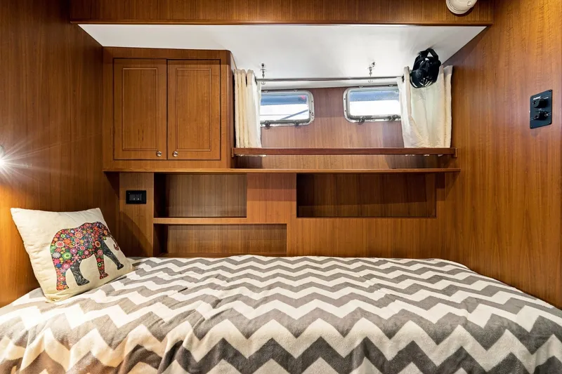 Slide: The Image of Cozy cabin interior of 2015 North Pacific NP49 yacht with wooden finish and decorative pillow. - 30