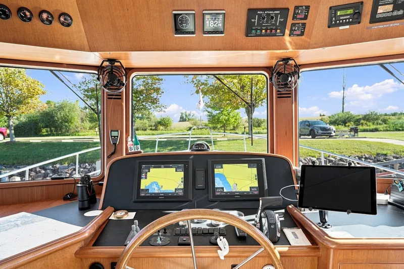 Slide: The Image of Pilothouse of 2015 North Pacific NP49 yacht with navigation screens and steering wheel. - 17