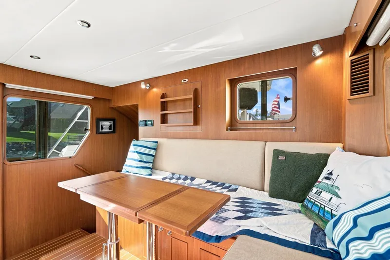 Slide: The Image of Interior of 2015 North Pacific NP49 yacht with cozy seating and wooden accents. - 20