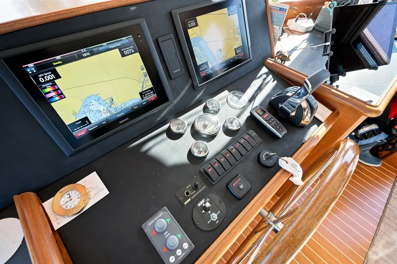 Slide: The Image of Control panel of a 2015 North Pacific NP49 yacht with navigation screens and gauges. - 18