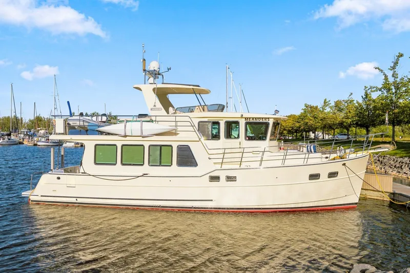 Slide: The Image of 2015 North Pacific NP49 yacht docked in a marina under a clear blue sky. - 1
