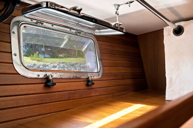 Slide: The Image of Interior of 2015 North Pacific NP49 yacht with wooden paneling and open porthole. - 35