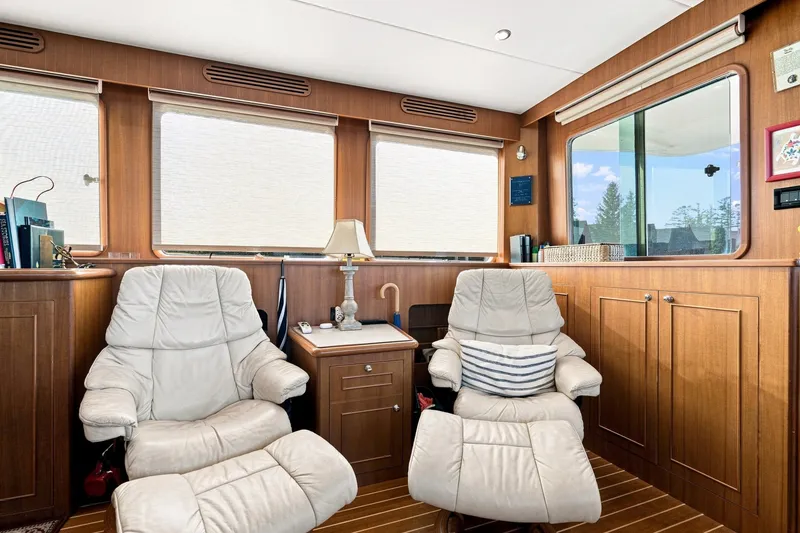 Slide: The Image of Luxurious interior of 2015 North Pacific NP49 yacht with leather chairs and wooden cabinetry. - 9