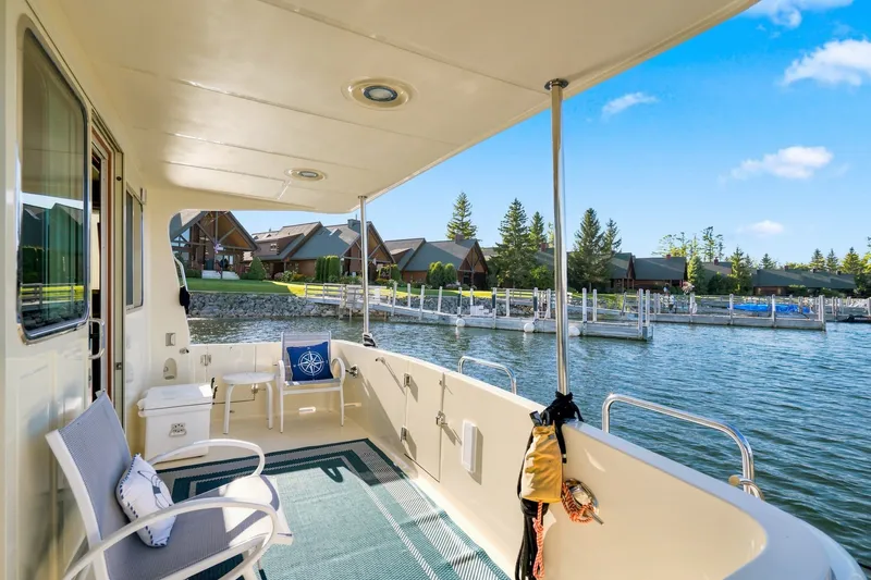 Slide: The Image of Covered deck of 2015 North Pacific NP49 yacht overlooking marina and waterfront homes. - 52